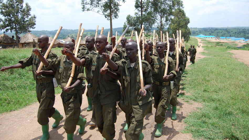 Somali soldiers march with sticks. Somali soldiers march with sticks.